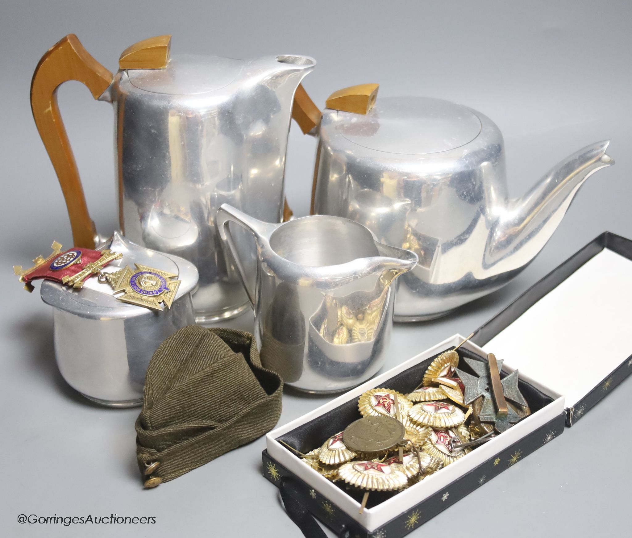 A four-piece Picquot ware tea set together with Russian and German military badges; other medallions etc.